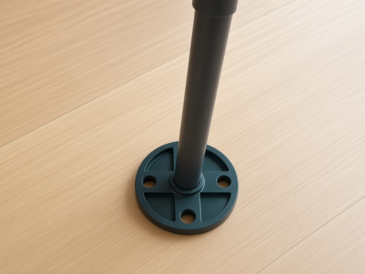 Black and blue pipe fitting on a wooden floor