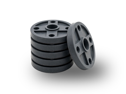 A stack of dark gray circular plastic discs with central holes, with one disc leaning against the stack on a clean white background.