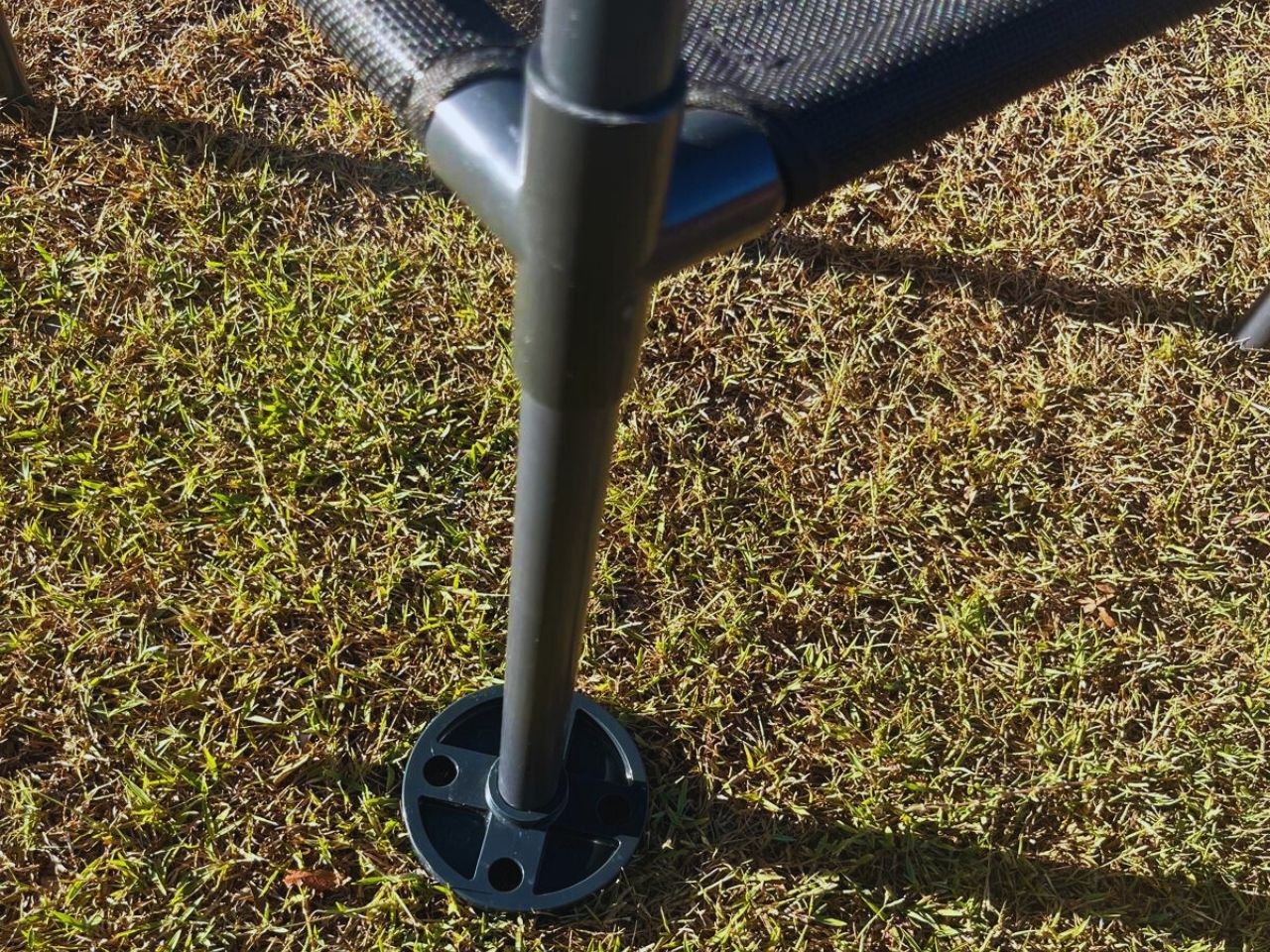 Chair leg with ground spike on grass