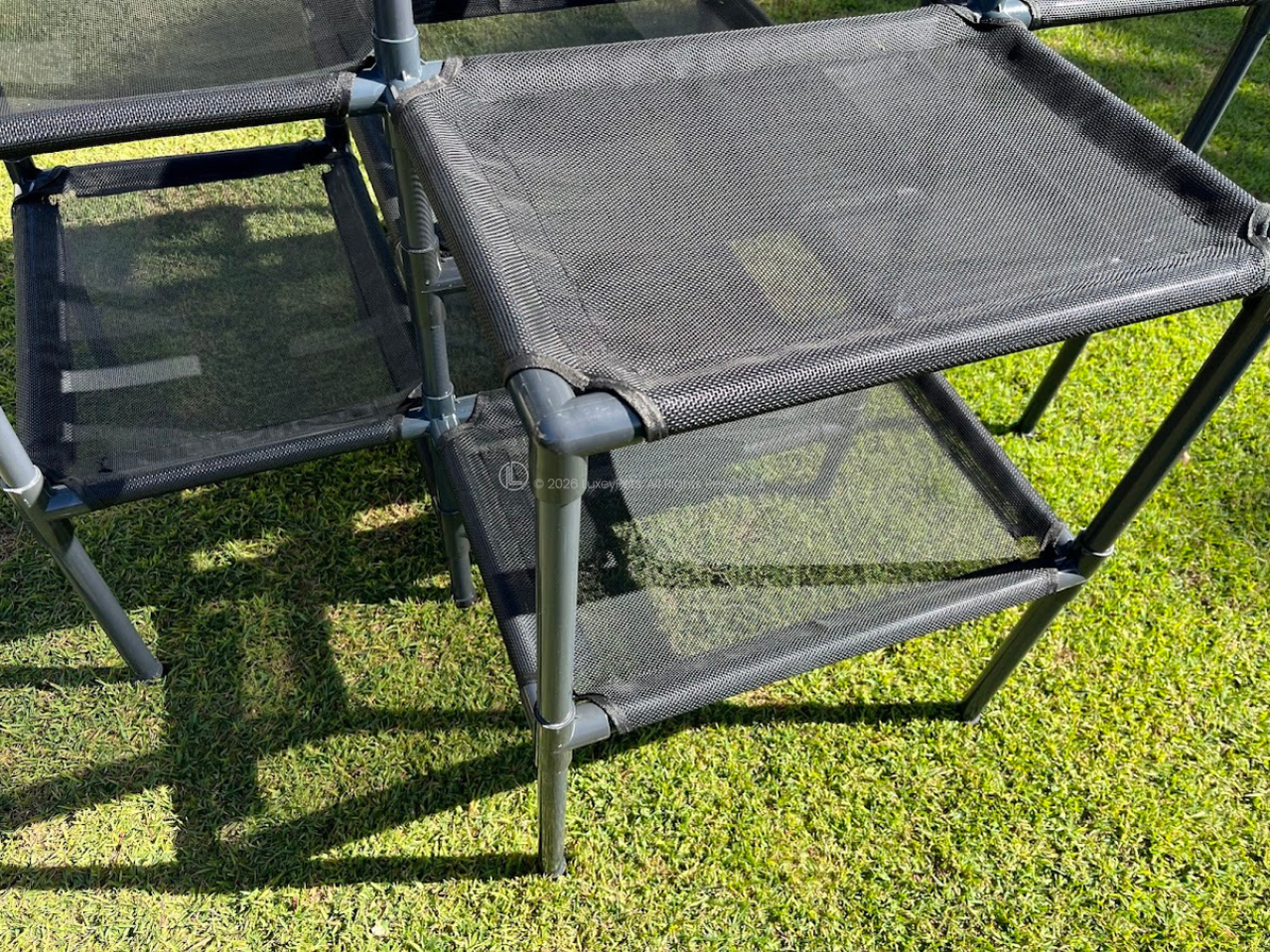 Black mesh cat tower on grass