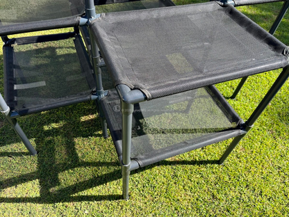 Black mesh cat tower on grass